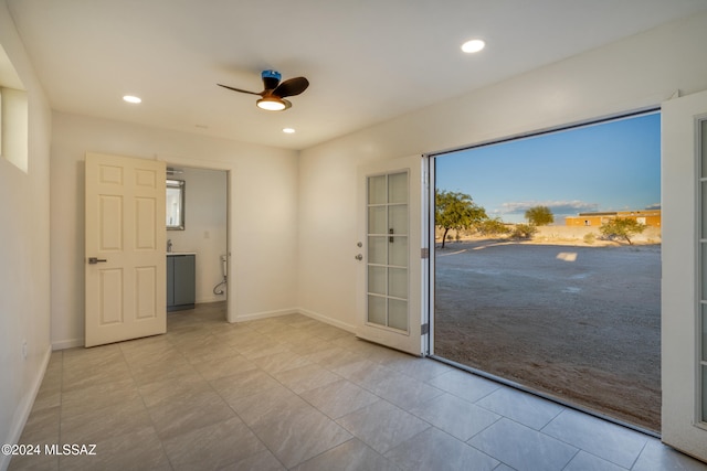 entryway featuring ceiling fan and light carpet