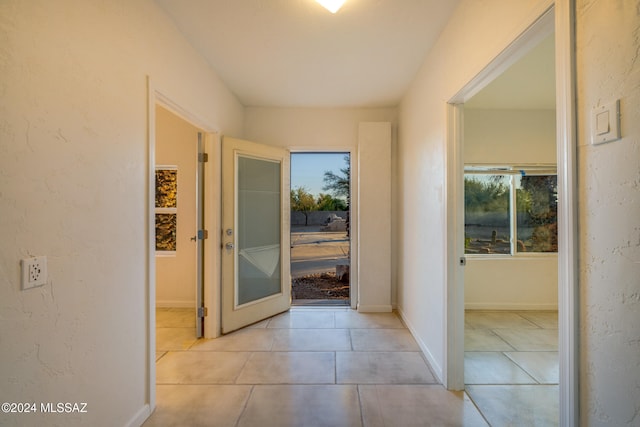 corridor with french doors and light tile patterned floors