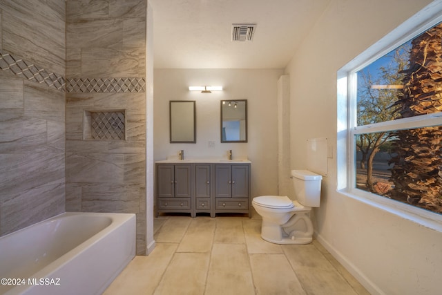 bathroom with tile patterned flooring, vanity, toilet, and a bathing tub