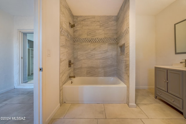 bathroom featuring tile patterned flooring, vanity, and tiled shower / bath combo