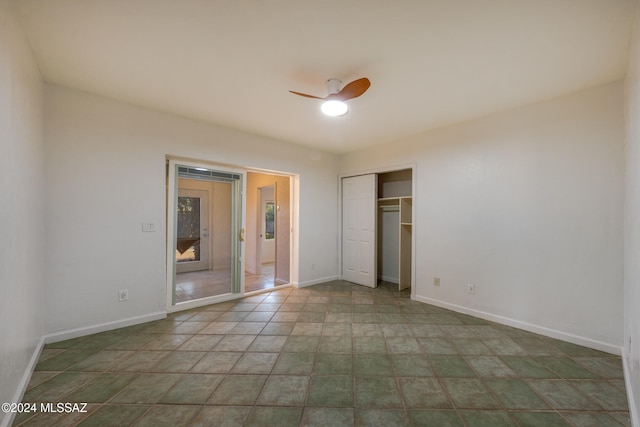 unfurnished bedroom featuring ceiling fan and a closet