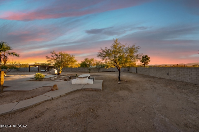 yard at dusk with a patio area