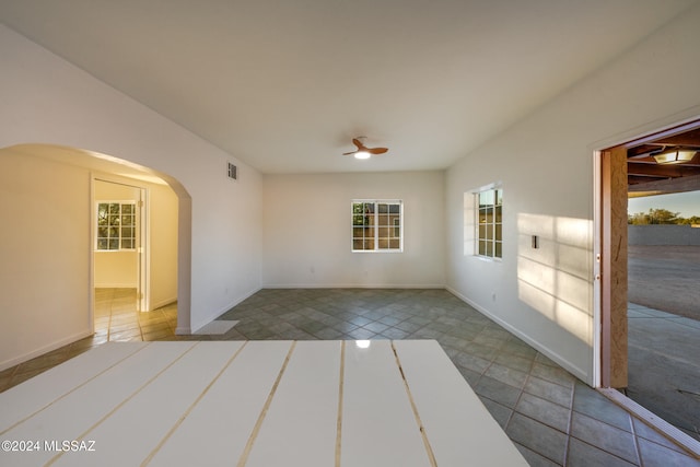 spare room with light tile patterned floors and ceiling fan