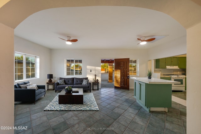 tiled living room featuring ceiling fan