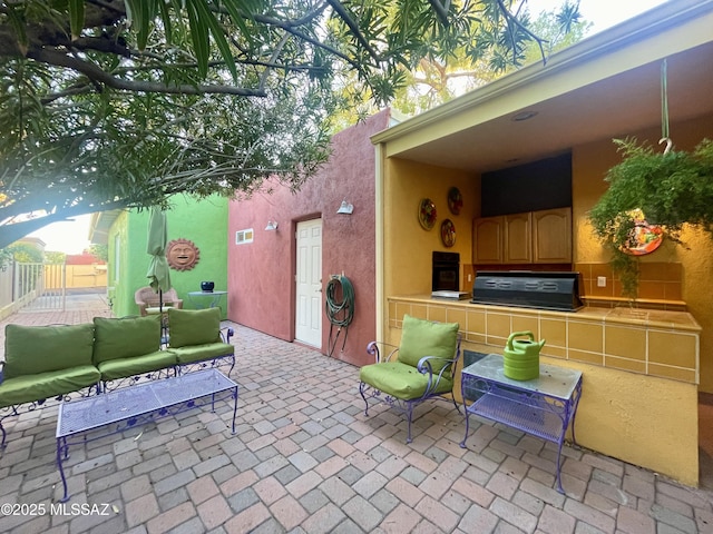 view of patio with area for grilling and an outdoor living space