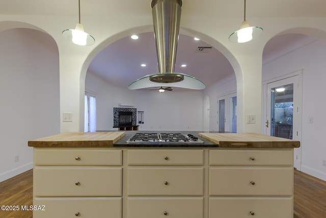 kitchen featuring wood counters, cream cabinets, visible vents, and dark wood-style floors