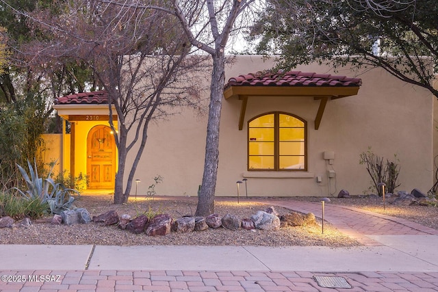 mediterranean / spanish-style house featuring stucco siding and a tiled roof