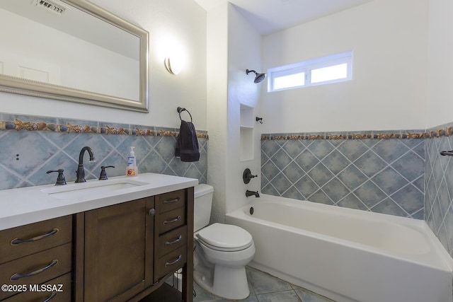 full bathroom featuring visible vents, toilet, vanity, tile walls, and  shower combination