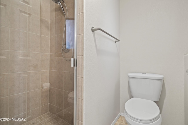 bathroom with toilet and an enclosed shower