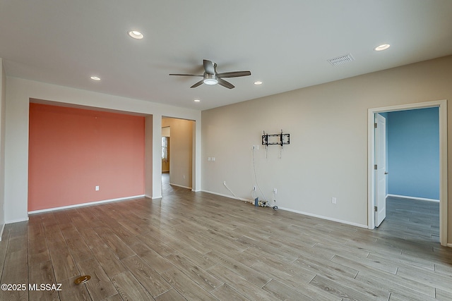 unfurnished room with a ceiling fan, recessed lighting, wood finished floors, and visible vents