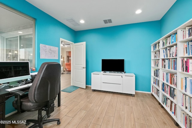 office area with light wood finished floors, baseboards, visible vents, and recessed lighting