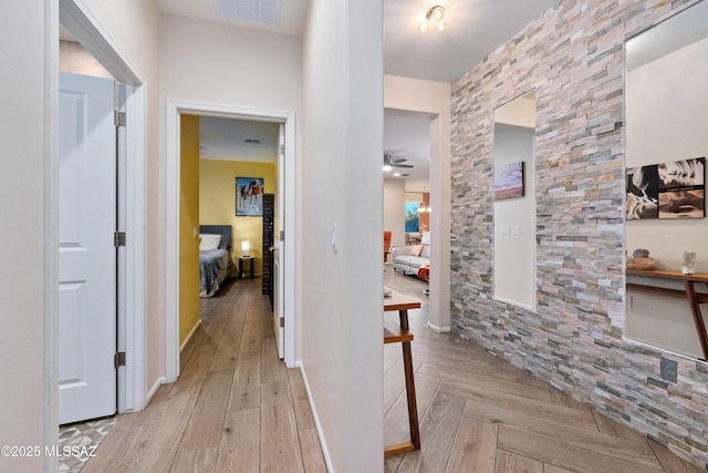 hallway featuring parquet flooring and visible vents