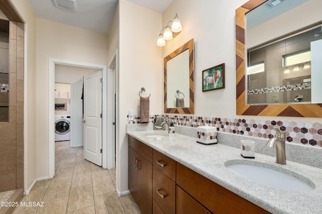 full bath featuring washer / clothes dryer, visible vents, a sink, and double vanity