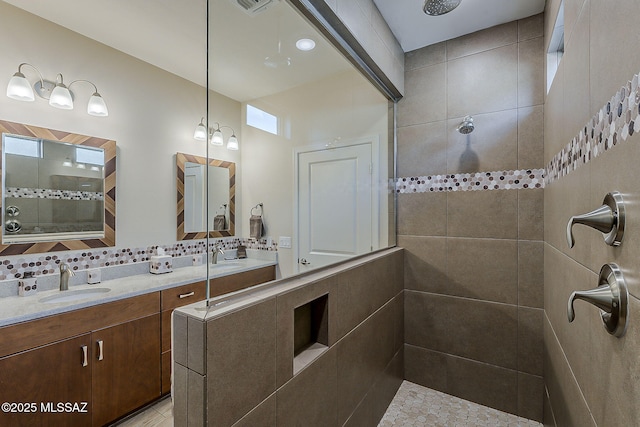 full bathroom featuring vanity and tiled shower