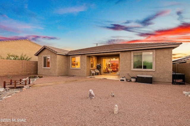 back of property with a patio area, a fenced backyard, and stucco siding