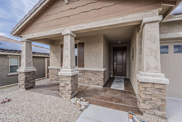 doorway to property featuring stucco siding, covered porch, and stone siding