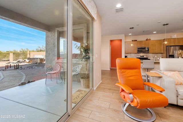 interior space with wood finish floors, visible vents, and recessed lighting