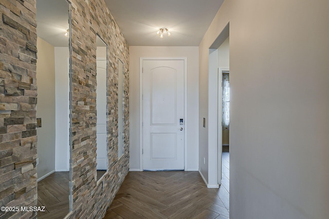 hall featuring baseboards