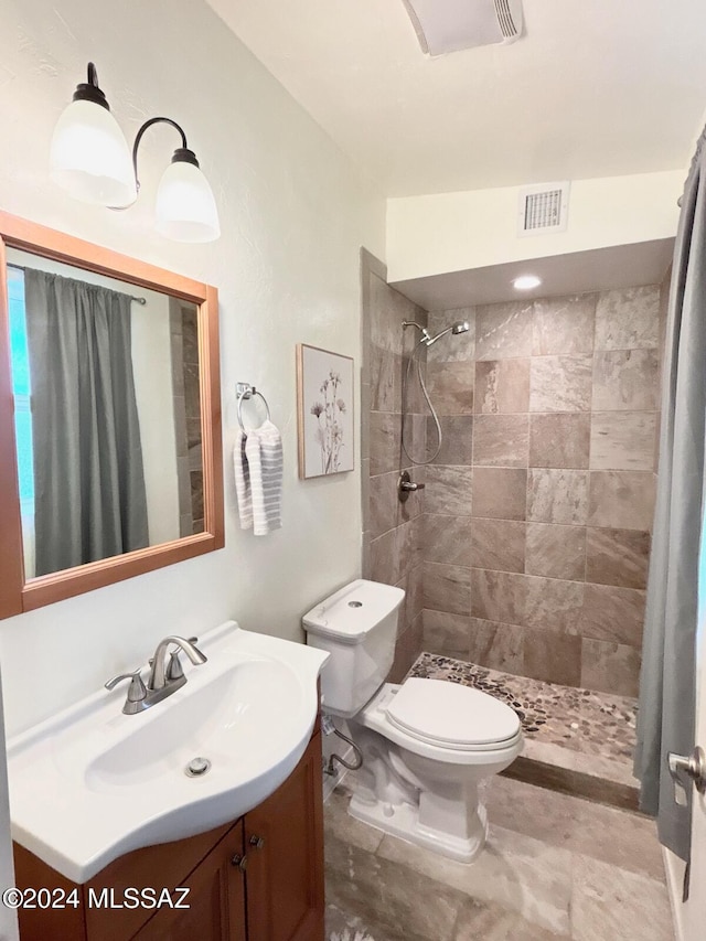 bathroom with a shower with curtain, vanity, and toilet