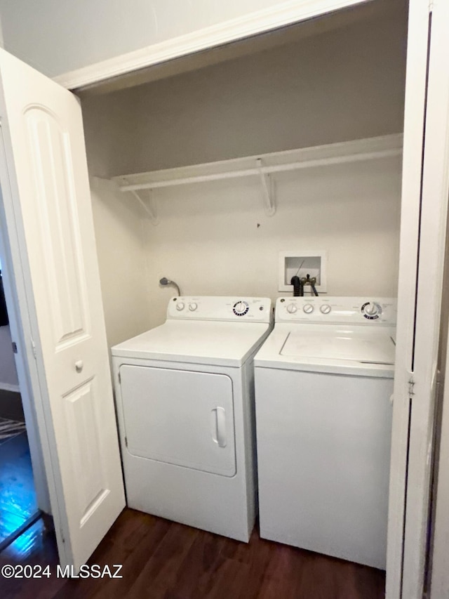 laundry room featuring dark hardwood / wood-style flooring and washing machine and clothes dryer