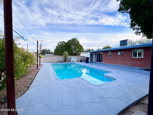 view of pool featuring cooling unit and a patio area