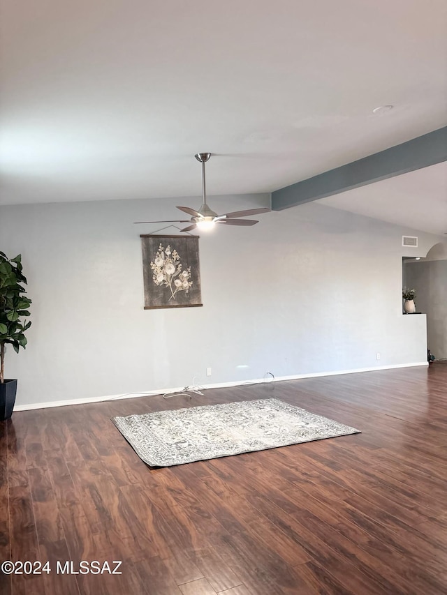 spare room featuring lofted ceiling, ceiling fan, and dark wood-type flooring