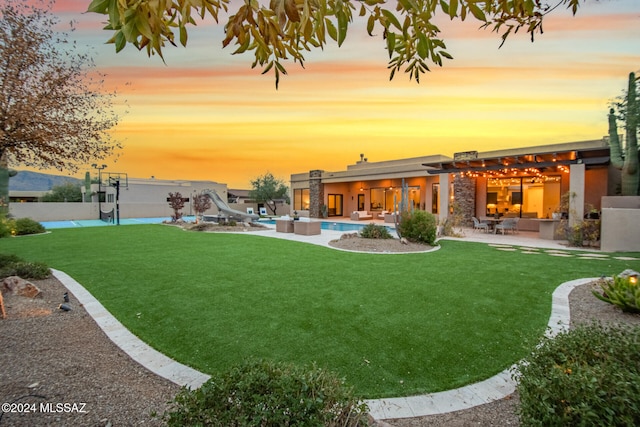 yard at dusk featuring a patio area