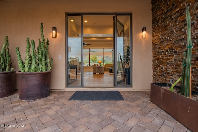 exterior entry at dusk with a patio