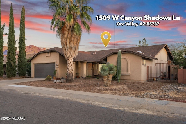 view of front of home with a mountain view and a garage