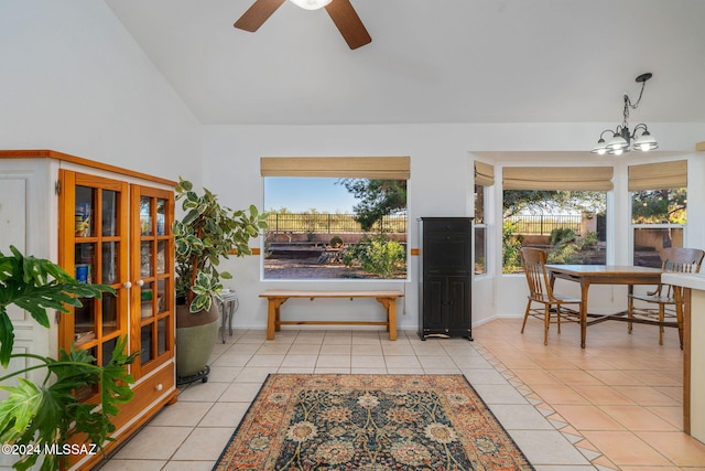 interior space with light tile patterned floors, a healthy amount of sunlight, and lofted ceiling