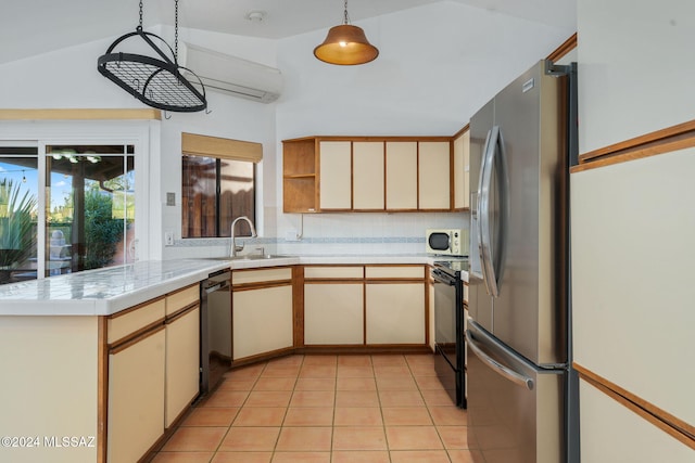 kitchen featuring pendant lighting, lofted ceiling, sink, appliances with stainless steel finishes, and kitchen peninsula