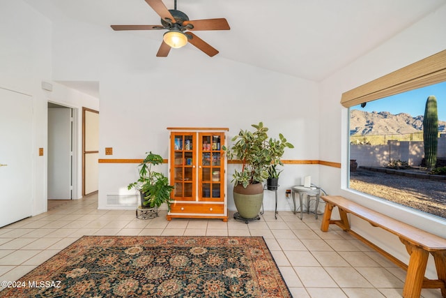 sitting room featuring a wealth of natural light, ceiling fan, light tile patterned floors, and high vaulted ceiling