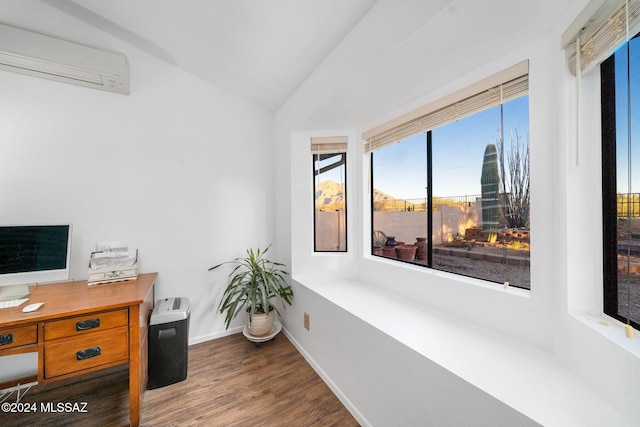 office space with a wall unit AC, dark hardwood / wood-style flooring, and vaulted ceiling