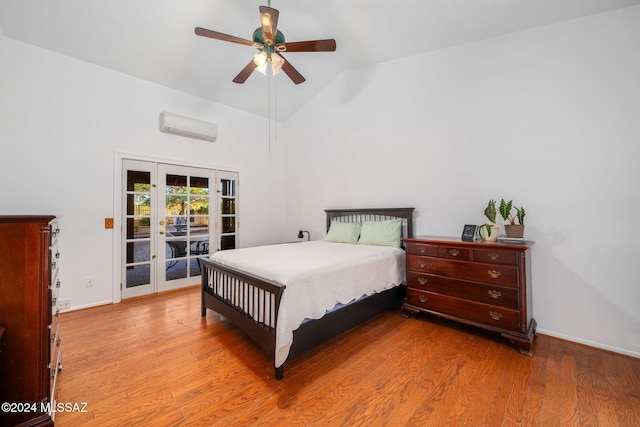 bedroom with french doors, vaulted ceiling, ceiling fan, a wall unit AC, and hardwood / wood-style flooring