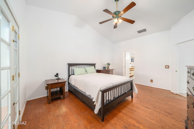 bedroom with ceiling fan, lofted ceiling, and hardwood / wood-style flooring