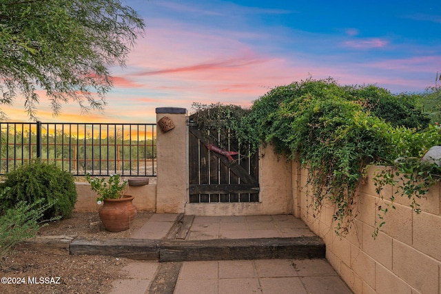 view of gate at dusk