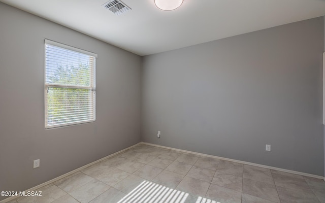 spare room with light tile patterned floors