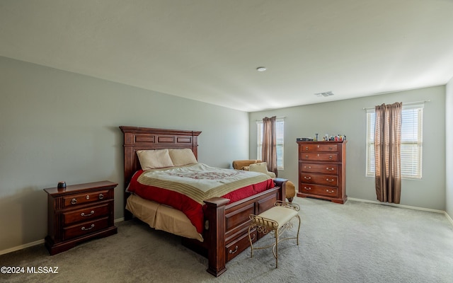 carpeted bedroom with multiple windows