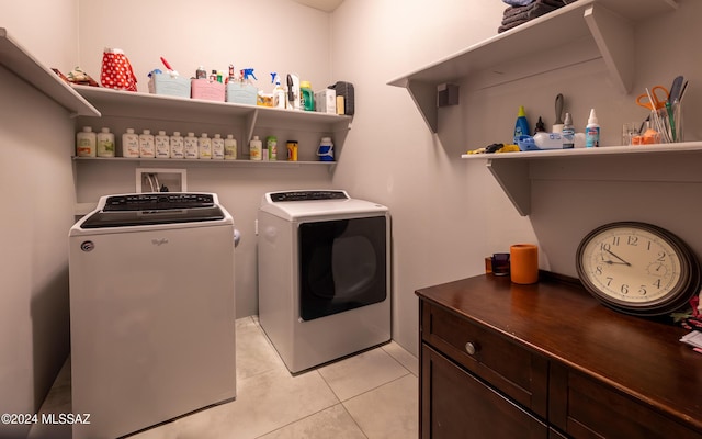 clothes washing area with light tile patterned flooring and washing machine and dryer