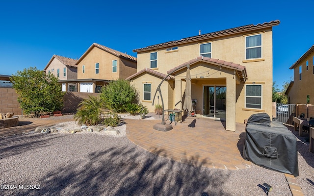 rear view of property featuring a patio area