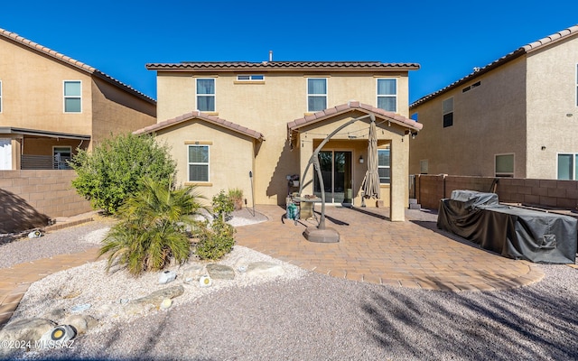 rear view of property featuring a patio area