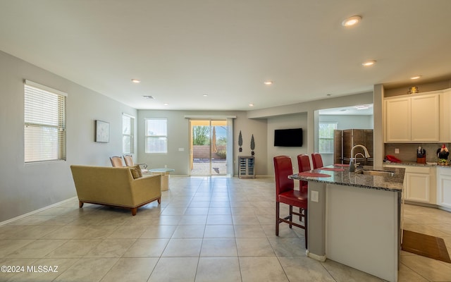 living room with light tile patterned floors and sink