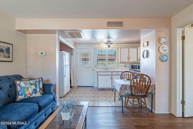 living room with sink and light wood-type flooring