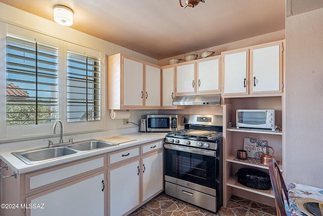 kitchen featuring stainless steel appliances, sink, and white cabinets