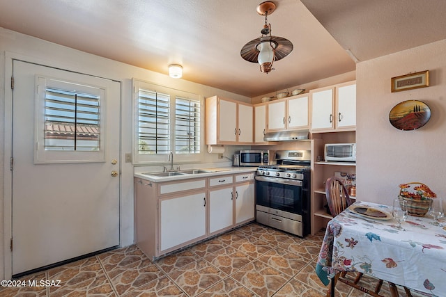 kitchen featuring appliances with stainless steel finishes, sink, and white cabinets