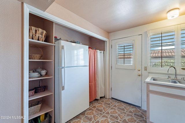 kitchen with white refrigerator and sink