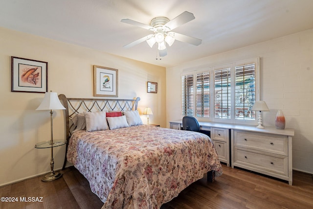 bedroom with dark hardwood / wood-style flooring and ceiling fan