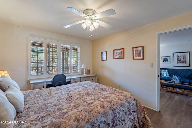 bedroom with ceiling fan, built in desk, and dark hardwood / wood-style flooring