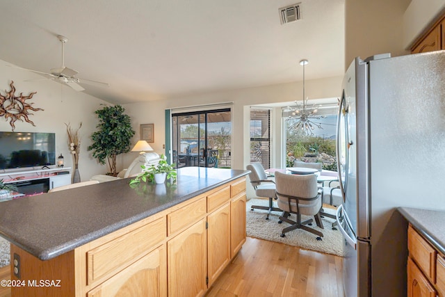 kitchen with light hardwood / wood-style flooring, stainless steel fridge, pendant lighting, lofted ceiling, and light brown cabinetry