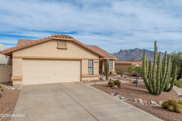 view of front of house featuring a mountain view and a garage